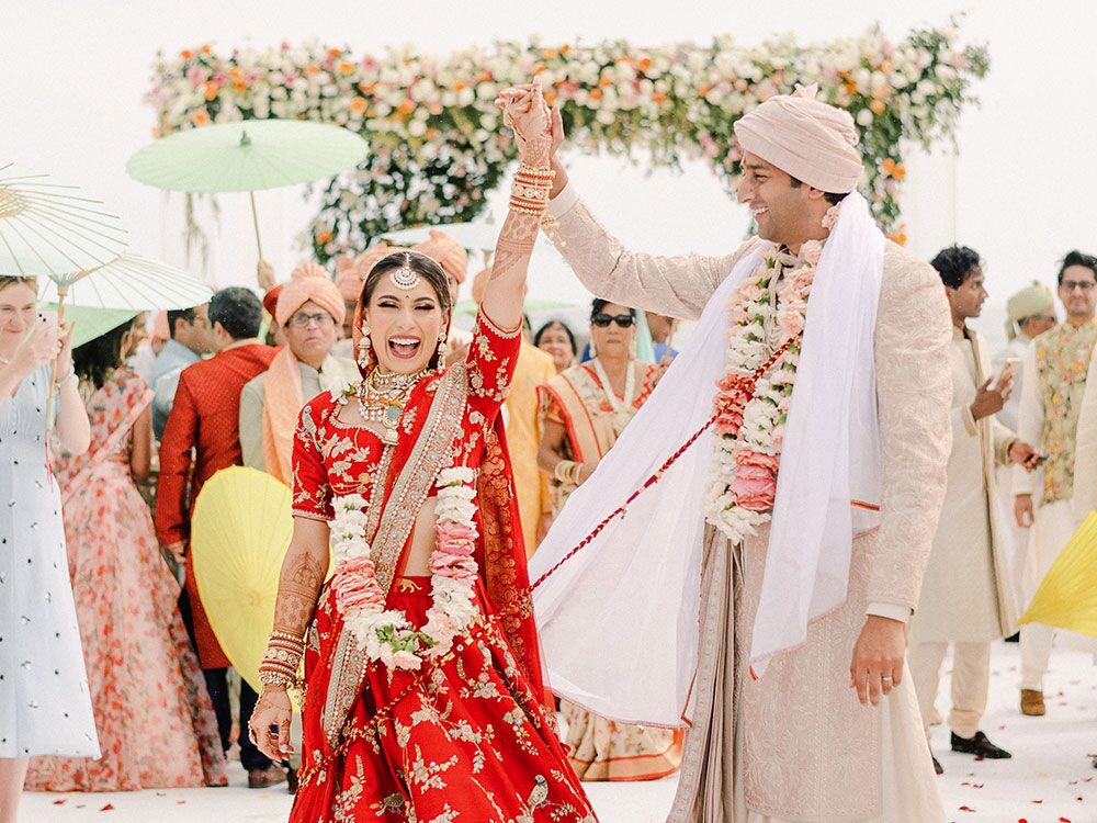 Indian bride and groom in traditional wedding clothes during recessional