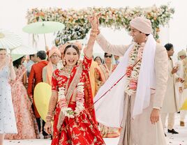 Indian bride and groom in traditional wedding clothes during recessional