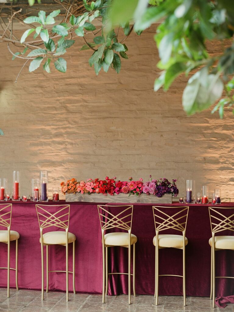 hightop wedding bar with gold chameleon chair barstools and ombre flower centerpiece