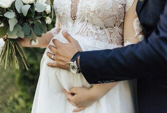 Close up of husband holding his wife's pregnant stomach