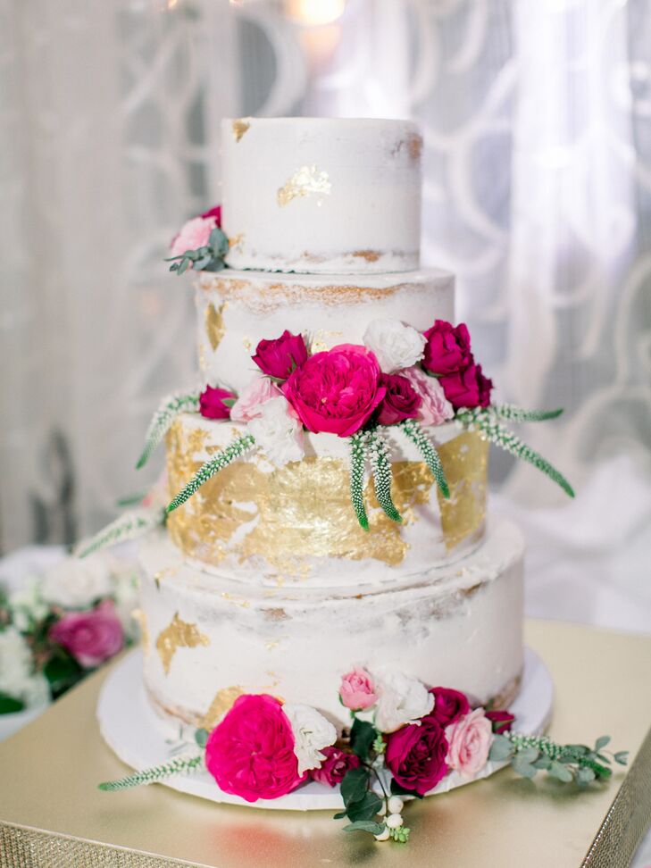 Four Tier Wedding Cake With Pink Flowers And Gold Leaf