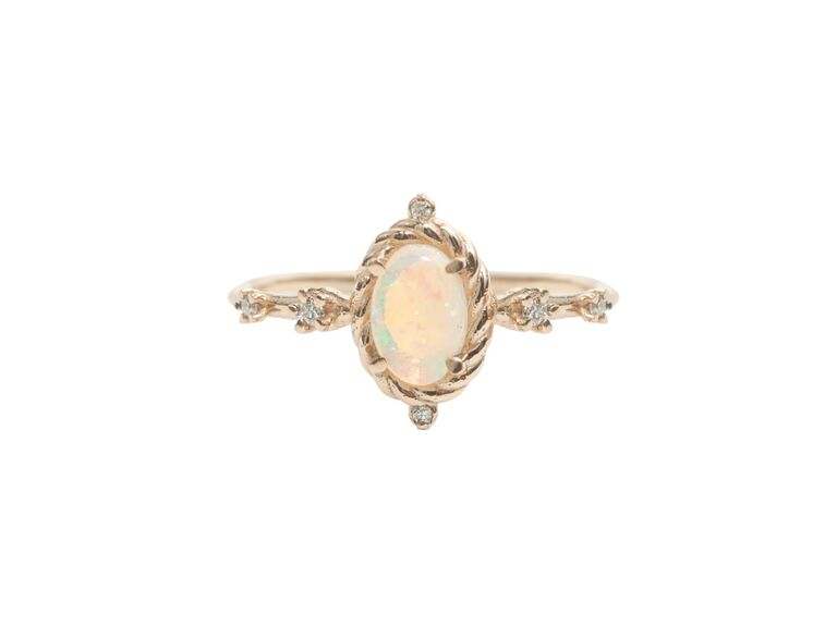 Opal engagement ring in braided gold frame with diamonds