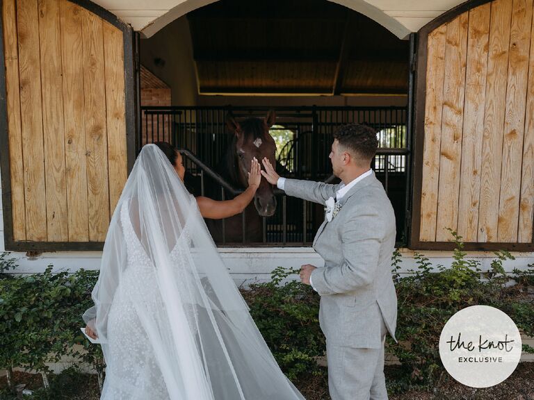 Erika Priscilla and Scott petting a horse at their destination wedding venue