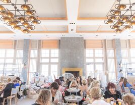 women enjoying lunch sitting at tables at bridal shower