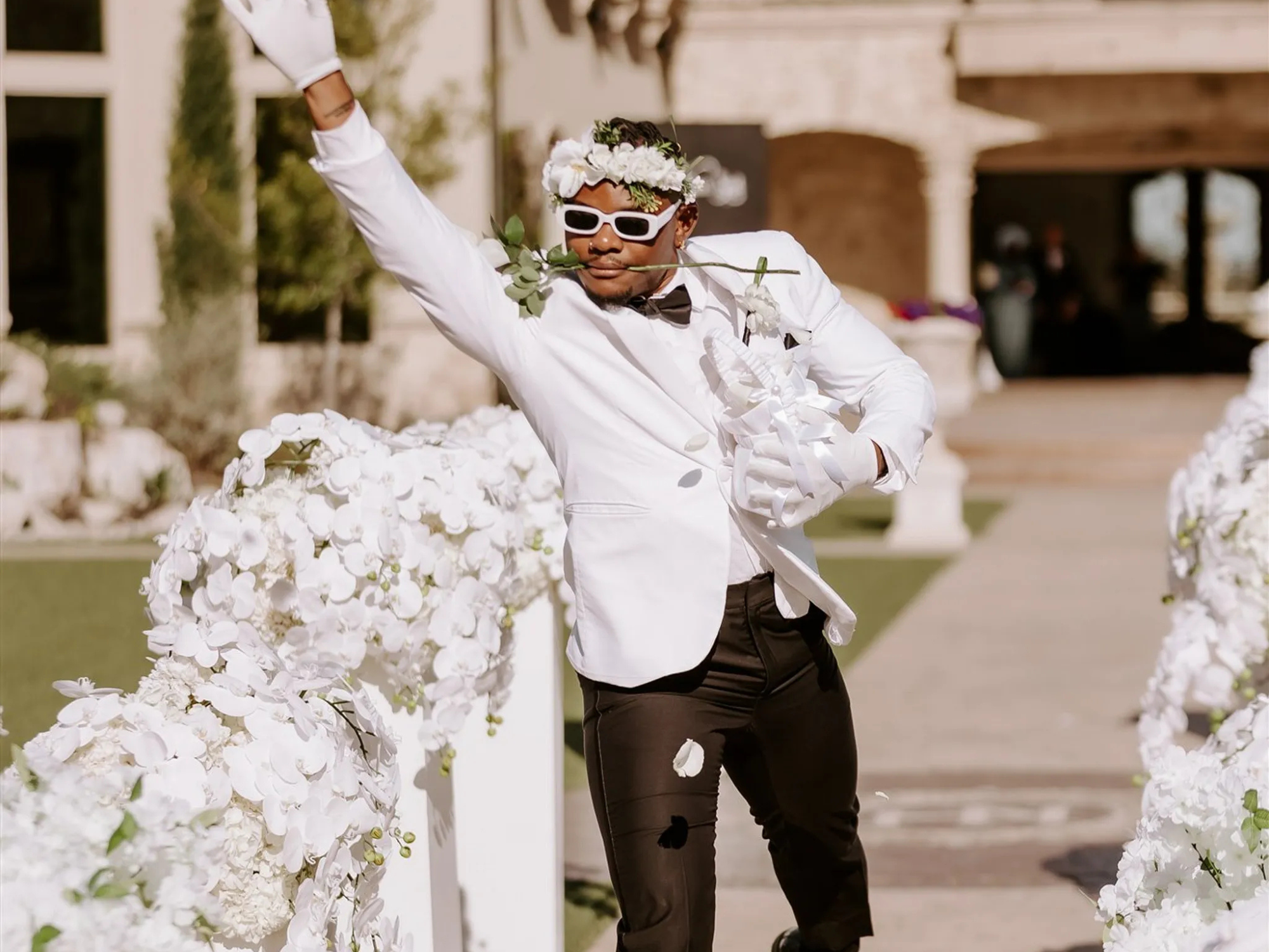 Adult flower guy tossing flower petals during ceremony processional, flower girl and ring bearer substitutes
