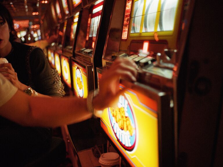 Couple playing slot machine in casino