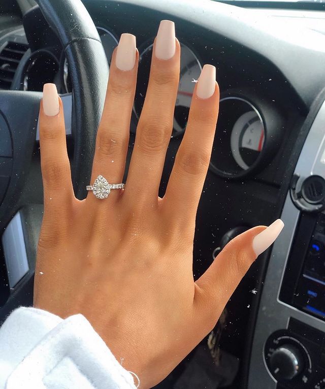 Engagement ring selfie in front of car steering wheel