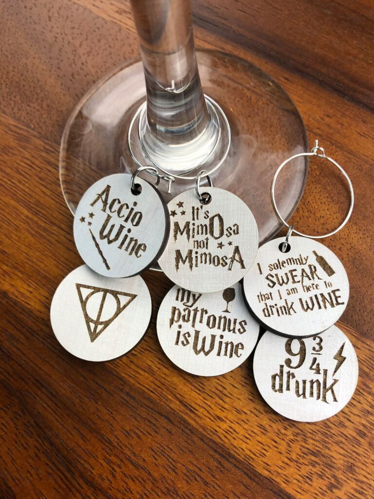 White wooden wine charms with engraved Harry Potter quotes and symbols