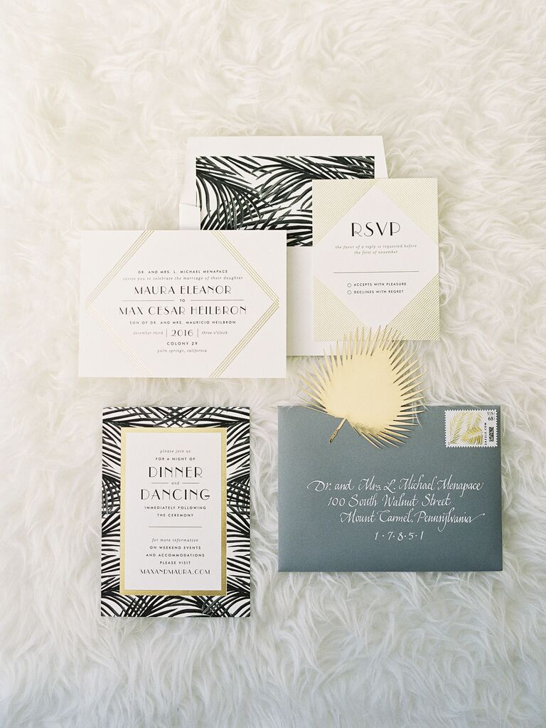 new year's eve wedding invitations with black tropical leaf border and gold geometric shapes
