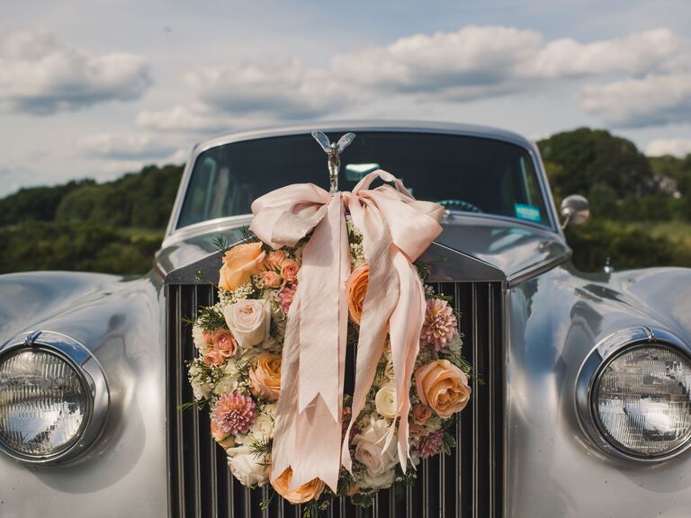 Classic getaway car decorated with a rose wreath on the front grill.