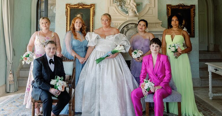 bride celebrating wedding plans and posing with bridesmaids and wedding party 