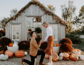 Man proposing to woman in fall pumpkin patch