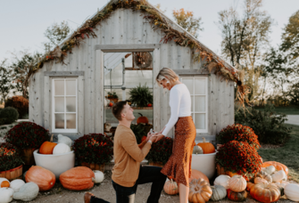 Man proposing to woman in fall pumpkin patch