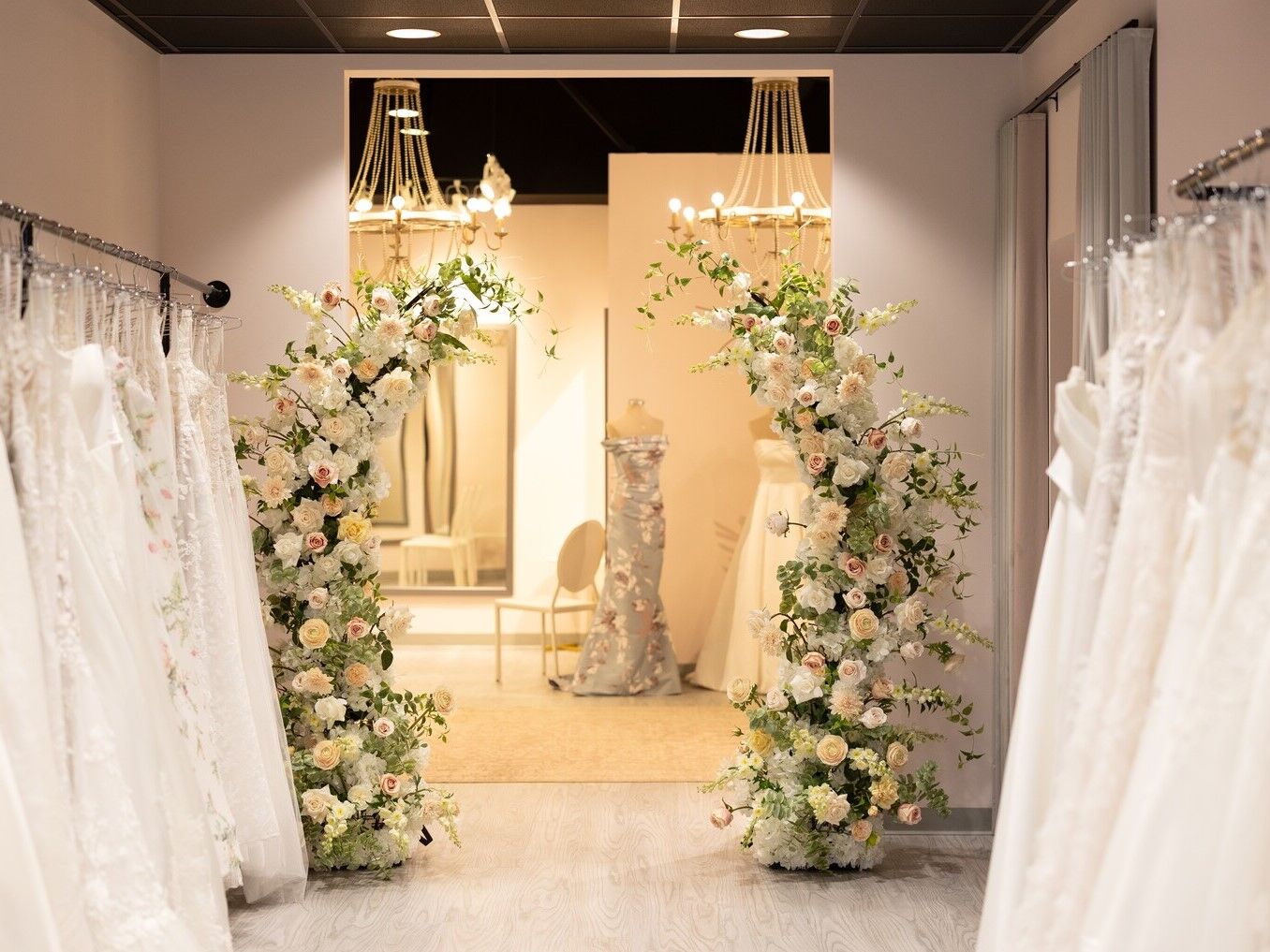 Inside bridal boutique dressing room with florals and dresses