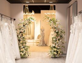 Inside bridal boutique dressing room with florals and dresses