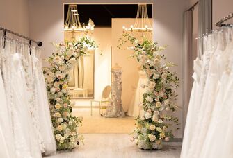 Inside bridal boutique dressing room with florals and dresses