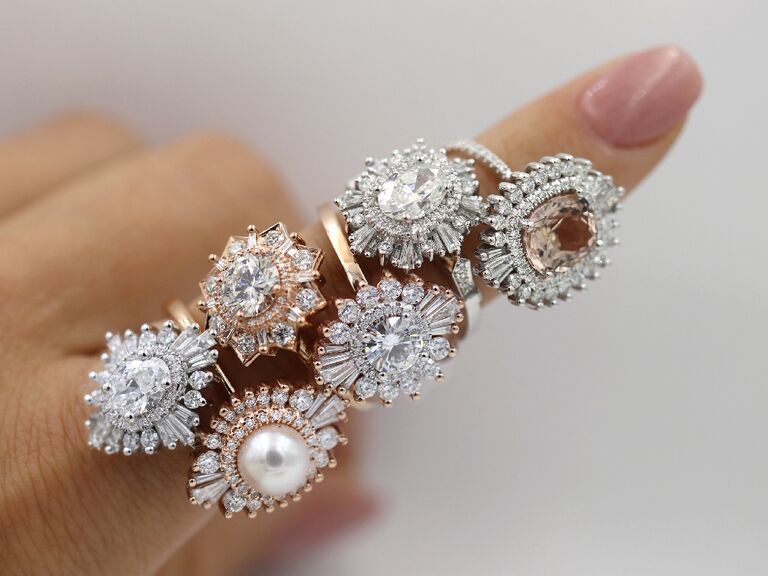 stack of six halo engagement rings on finger
