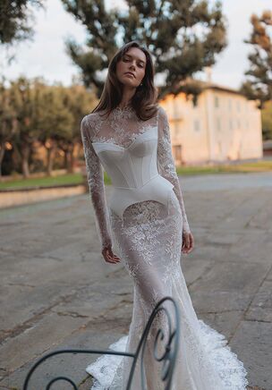 Meticulously detailed embroidery over the translucent long sleeve top and smooth mermaid tail skirt.