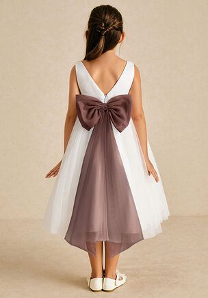 Kavi is our adorable flower girl dress cut from satin and tulle. She features a scoop neckline paired, the look is complete with an A-line skirt. This dress is not only perfect for a flower girl at a wedding but also versatile enough for other special occasions.