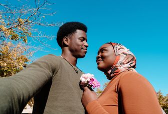 Happy couple looking at each other while taking a selfie