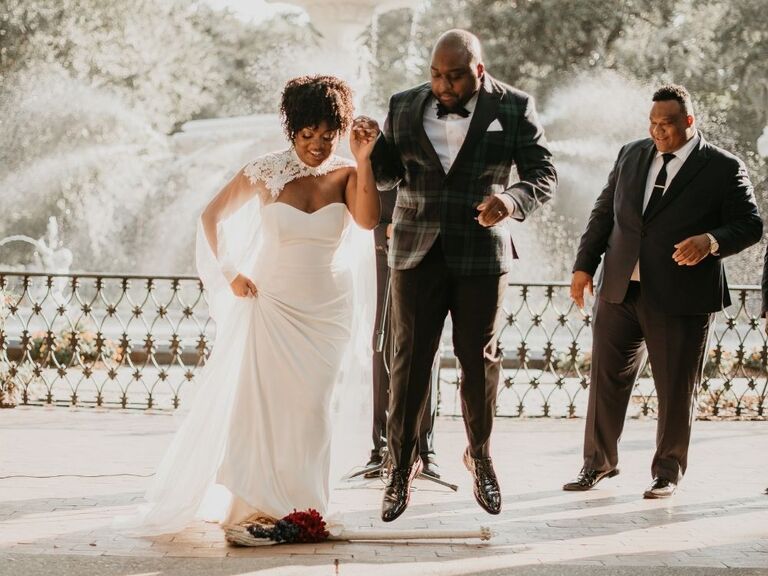 couple jumping the broom at wedding in Georgia