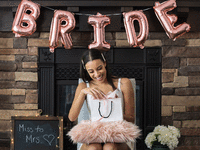 Bride opening bridal shower gift at a bridal shower party. 