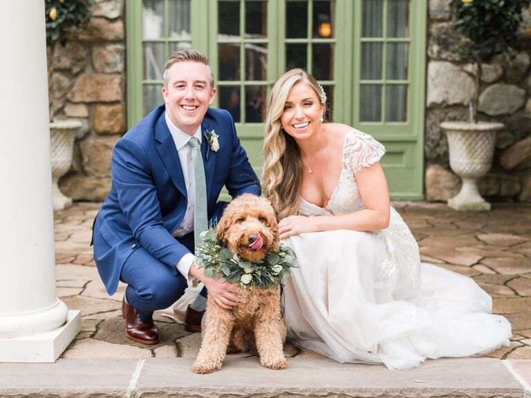Happy couple on their wedding day with their pet
