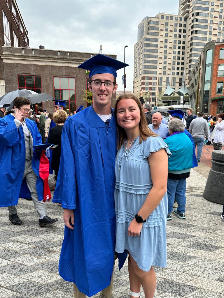 Austin graduates from GVSU with Maddie at his side.