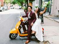 Brides on scooter after wedding