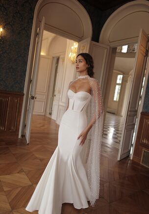 Chic mermaid gown with a soft sweetheart neckline and triangular mesh embellishments uprising from the waistline. The dress is complemented with a sheer tulle veil, adorned with pearls, descending from a choker and draping over the train.