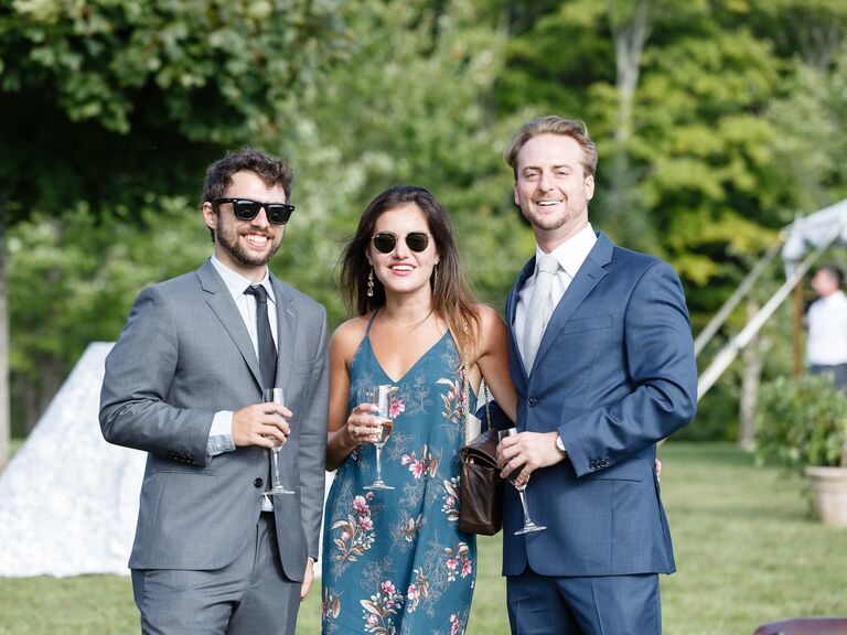guests holding wine glasses at outdoor engagement party