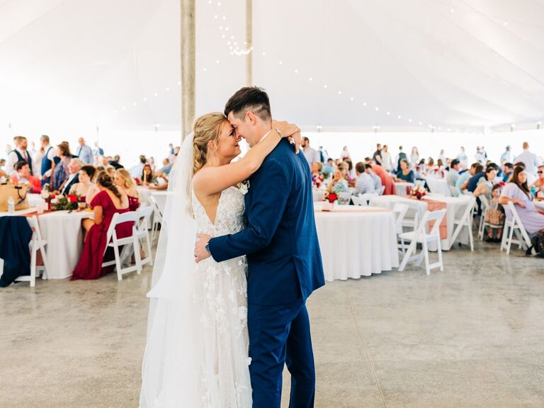 Couple during their first dance in an event tent