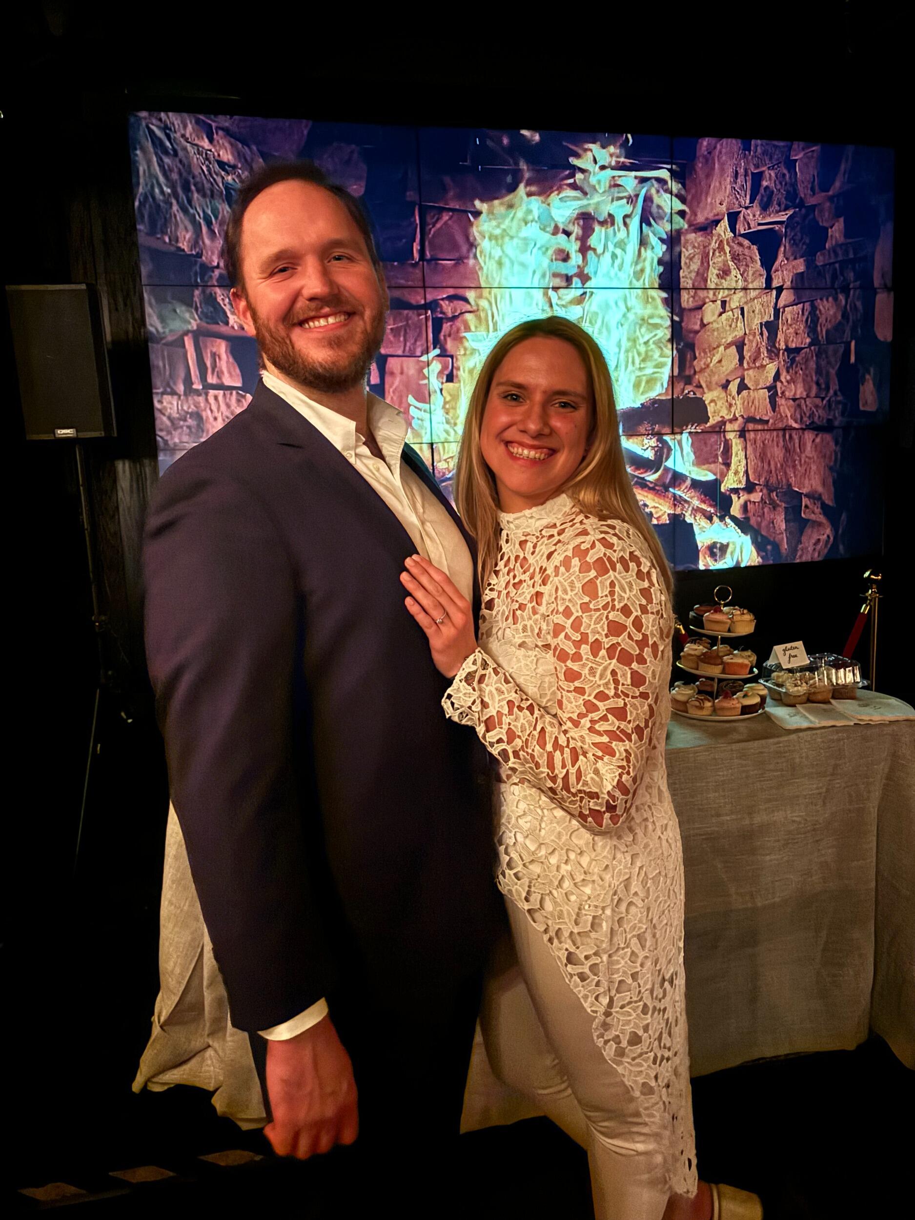 Celebrating our engagement with our friends at the bar where we had our first date