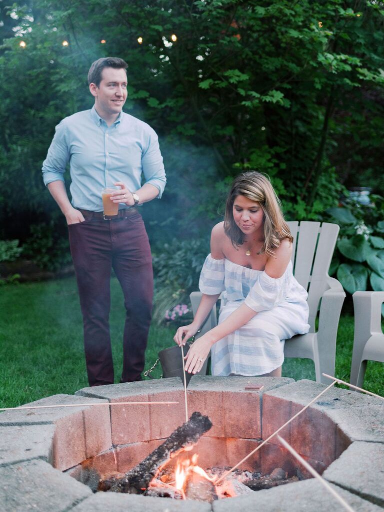 Bride and groom roasting S'mores at casual outdoor backyard summer wedding