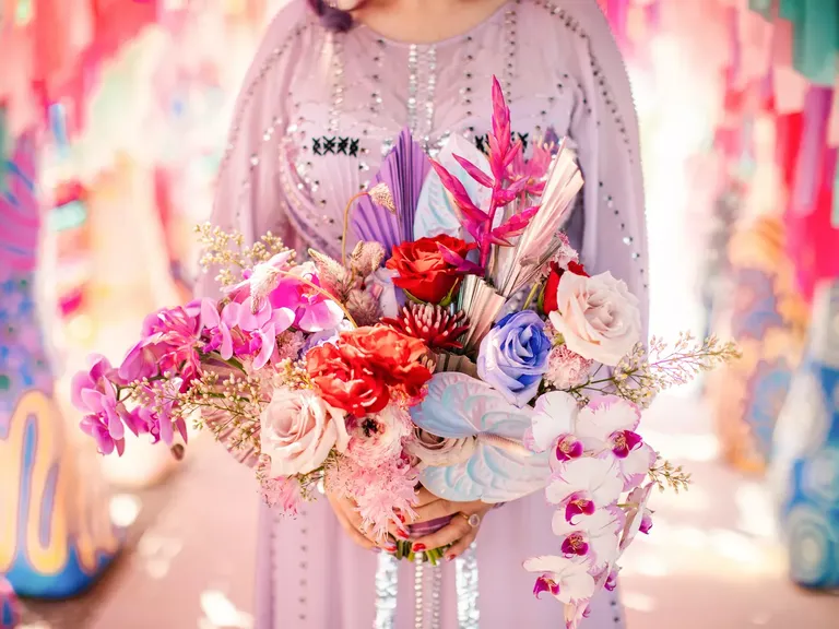 Bride in Purple Wedding Dress Holding Colorful Bouquet