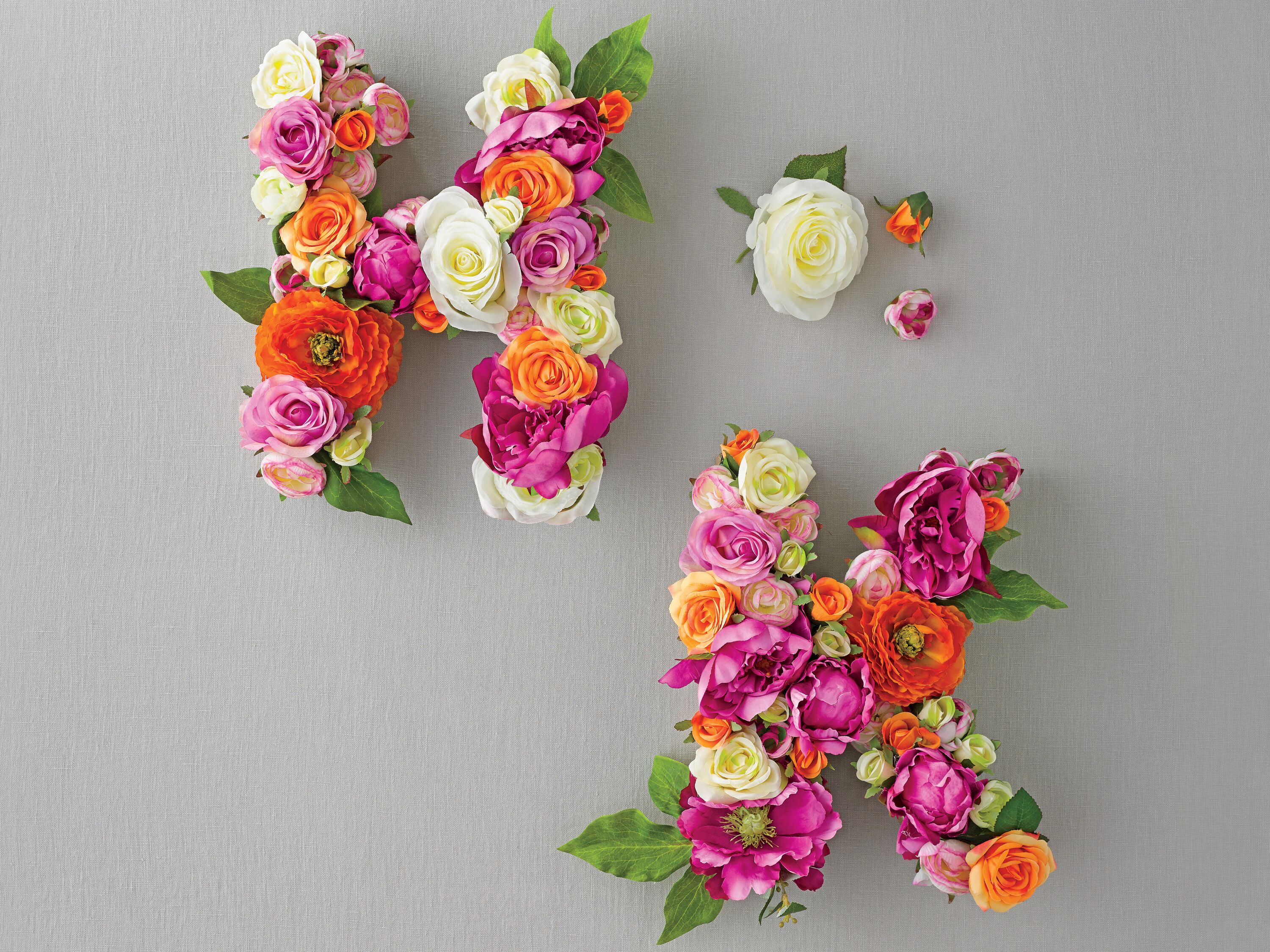 Initial monograms with silk flowers and cardboard letters