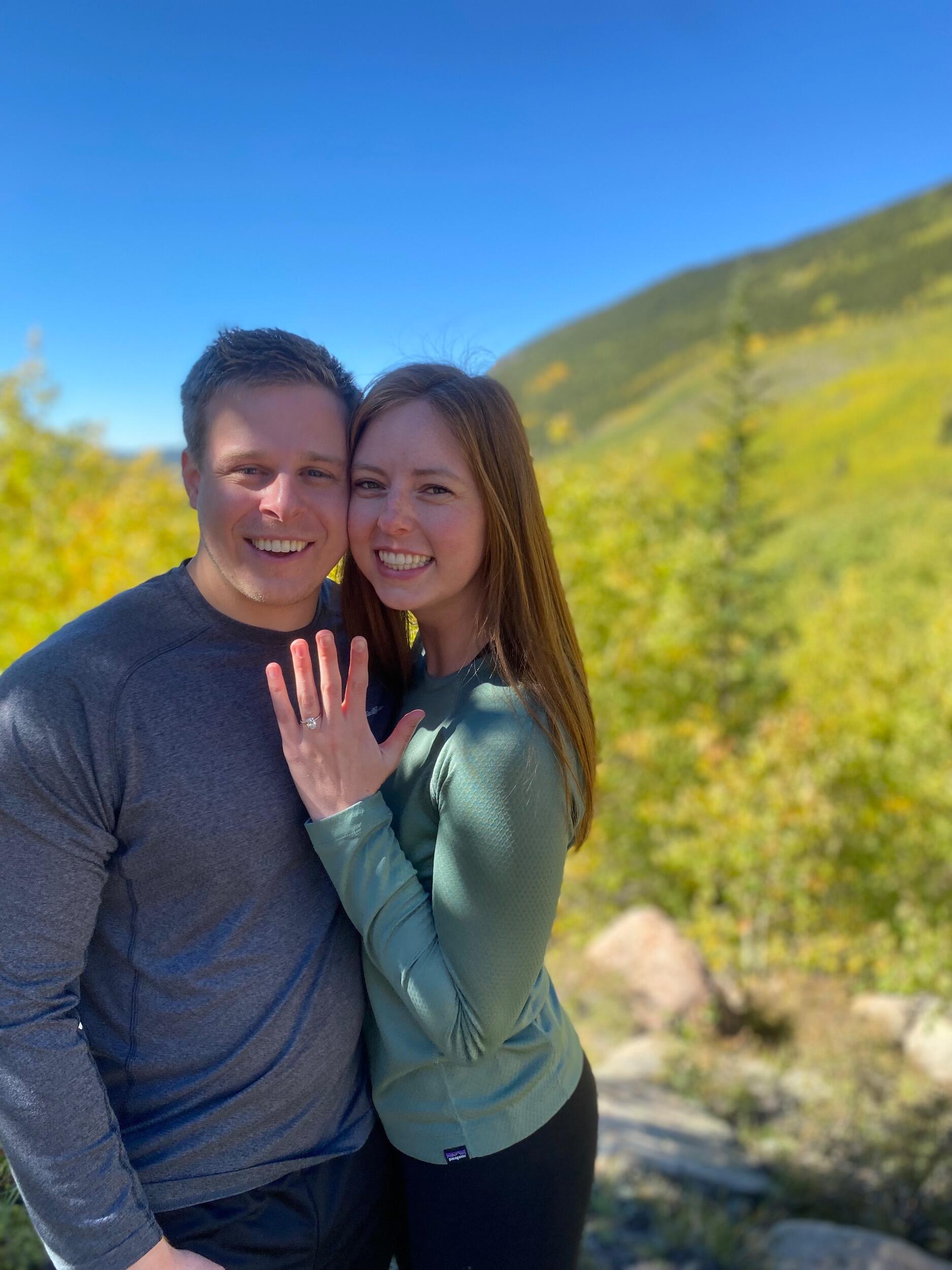 Jerdan decided that he was going to propose, but it had to be a surprise. I’m not very good at letting surprises happen, so when I figured out that a proposal was coming, I began being suspicious of everything! Over the fall time we had a hike planned for just about every weekend. Fall and hiking are our favorite things, so I had a feeling that’s when it would happen. Before each hike I would check the backpack for a ring and pat down Jerdan’s pockets in search of anything out of the ordinary. Of course, he had a plan to ensure it was a surprise despite my suspicions. Jerdan had my brother take a table, a card, and the ring up on a hike to an overlook off the trail. Jerdan led me out there and proposed, and of course, got an excited “yes, yes, yes!”