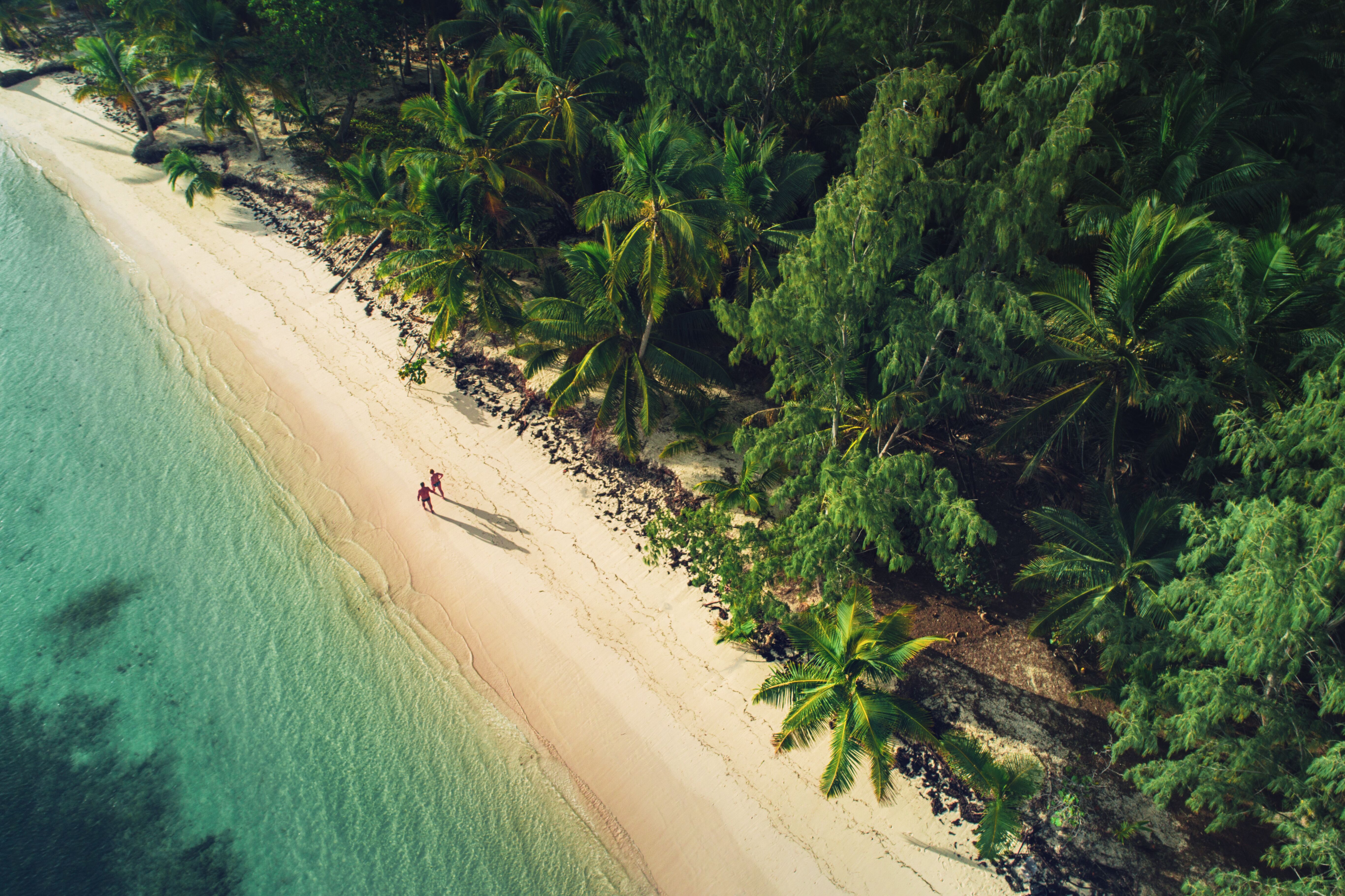 A couple walks along inviting sands of a beach in the Dominican Republic
