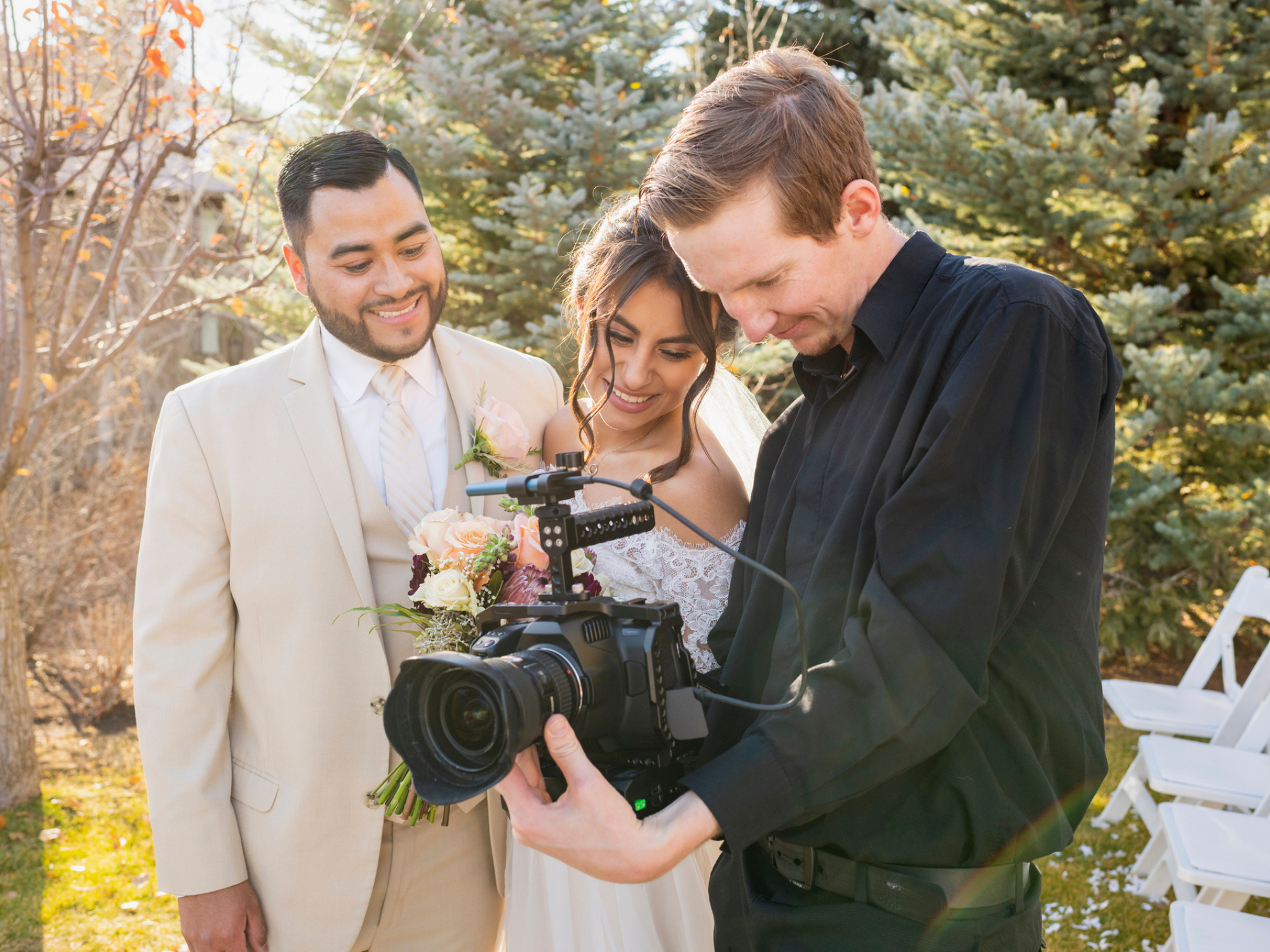 Couple looking at footage with wedding videographer