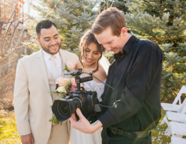 Couple looking at footage with wedding videographer