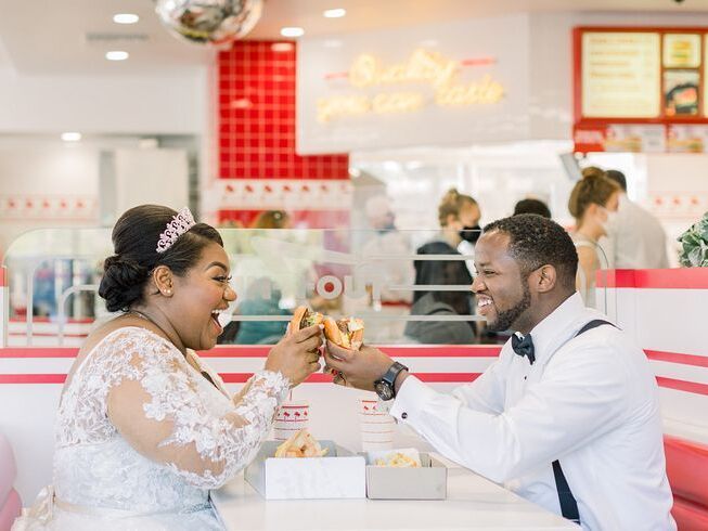 Couple sharing burger at In 'n' Out