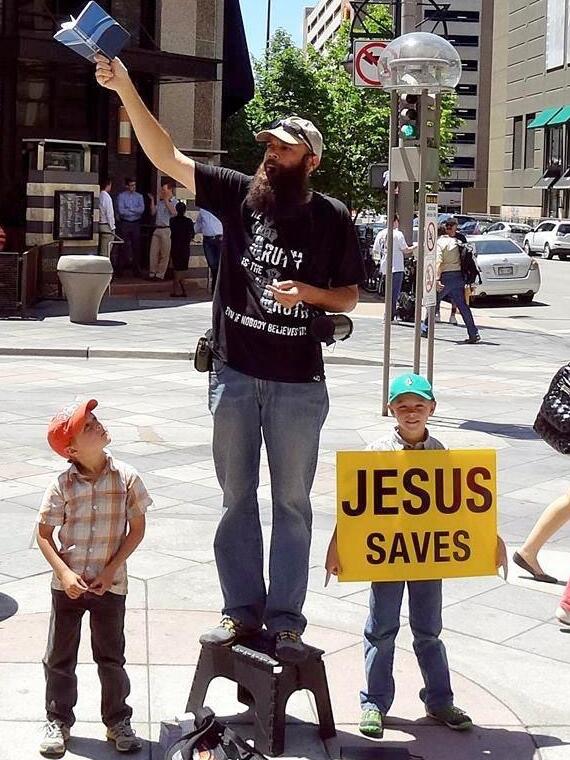Caleb and his family began to Evangelize in Colorado Springs regularly; they would spend entire days handing out tracks, holding Bible verse signs, and preaching the Gospel on sidewalks outside of abortion clinics, parks, and plazas. Caleb loved the “Jesus Saves” sign because people either loved or hated it. 
