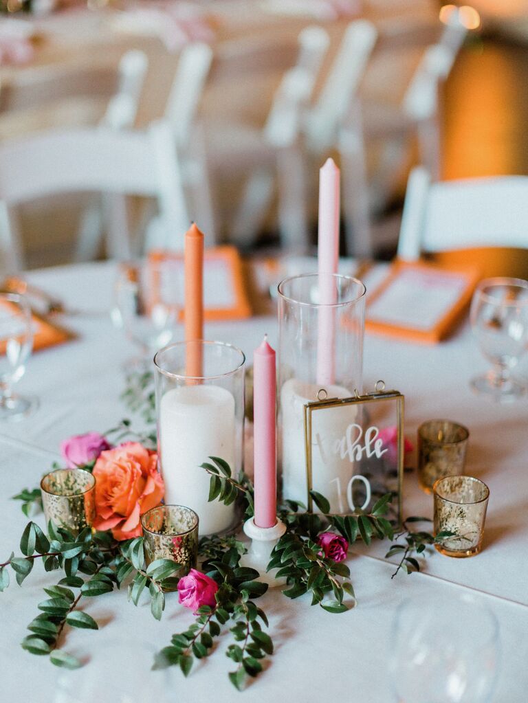 small wedding centerpiece with pink and orange taper candles