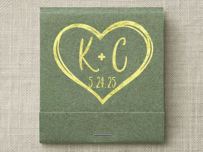 Single green matchbook with gold foil heart surrounding a couple's intails and wedding date