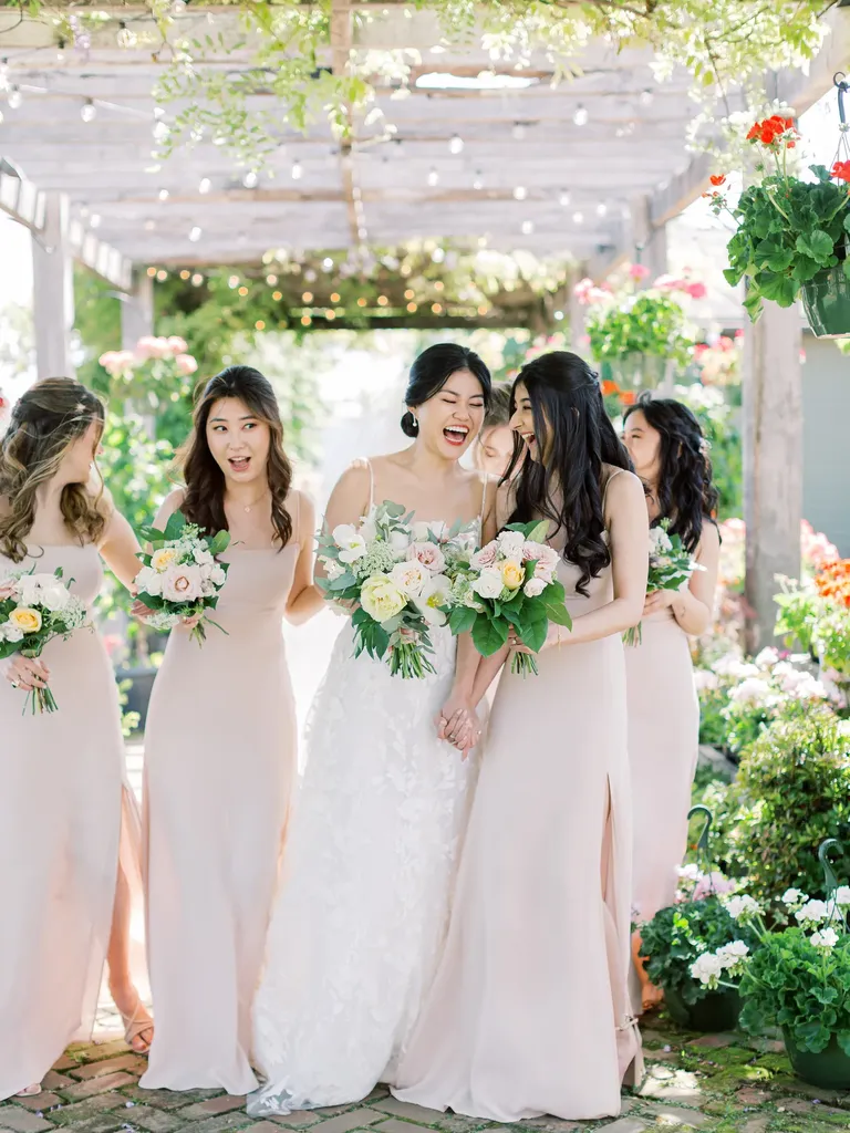 Bridesmaids and bride laughing together