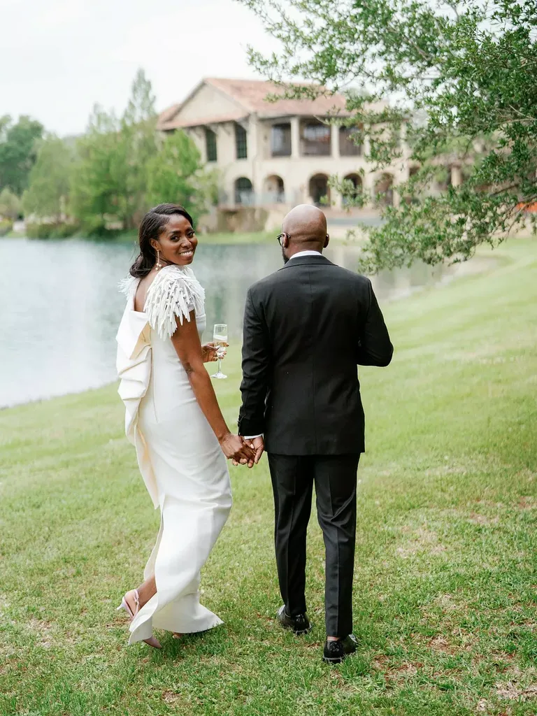 Couple Walking Beside Lake Post-Ceremony at The Club at Houston Oaks in Texas