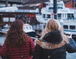 two women walking along the seattle pier