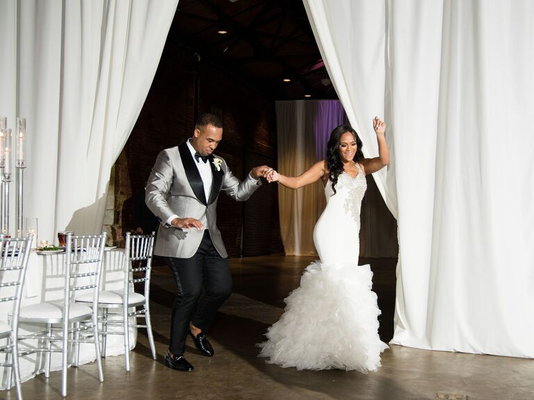 bride and groom in formal attire dance through wedding reception venue