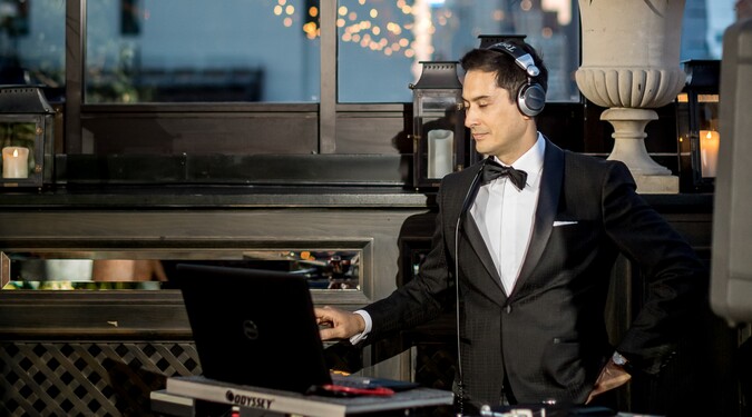 DJ wearing headphones while playing music at an event.