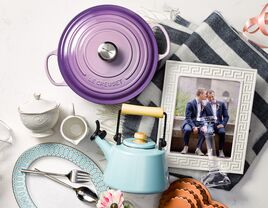 Wedding gifts laid out on table with picture of couple